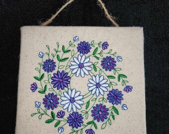 Embroidered wreath wall hanging on canvas