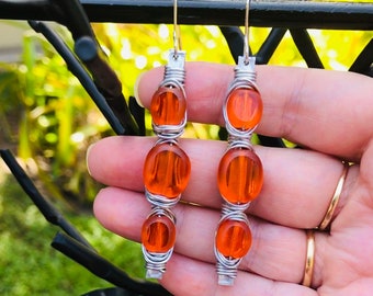 Shiny Aluminum Stick Earrings Featuring Vivid Contrast Medicine Bottle Orange Art Glass Oval Table Beads