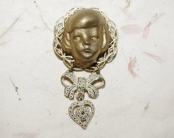 Gilded Frozen Charlotte Head Filigree Brooch with Bow