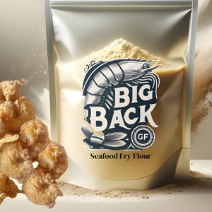 May include: A silver pouch of "BIG BACK" Seafood Fry Flour with a shrimp graphic and "GF" symbol. Fried seafood is in the foreground. The flour is light beige, and the background is a neutral tone.