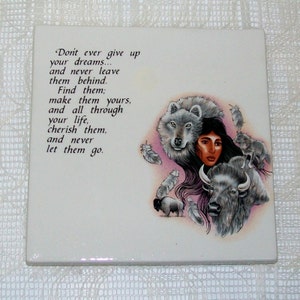 May include: A white ceramic tile with a quote about dreams and a colorful illustration of a Native American woman with a wolf, a buffalo, and feathers. The quote reads: "Don't ever give up your dreams... and never leave them behind. Find them; make them yours, and all through your life, cherish them, and never let them go."