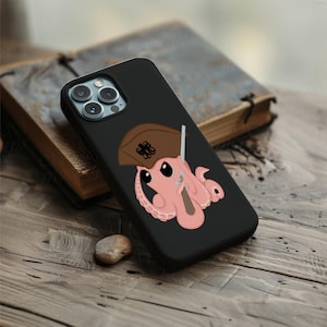 May include: Black phone case featuring a cartoon octopus wearing a pirate hat and holding a sword. The octopus is pink with black eyes and tentacles. The hat is brown with a decorative emblem. The phone case is on a wooden surface.