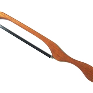 May include: A wooden-handled saw with a black metal blade. The handle is curved and has a smooth, polished finish.