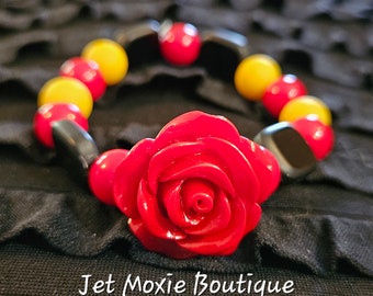 Red rose bracelet. Many unique designs ranging from classy, chic, to funky. Check out the Jet Moxie Boutique