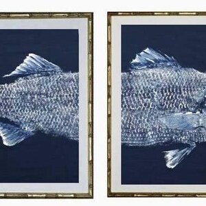 Front and back half of a striped Bass Gyotaku fish rubbing. White ink on a navy-blue background.