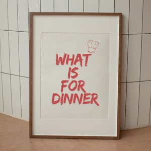 May include: A framed print with the text "WHAT IS FOR DINNER" in red lettering with a chef's hat icon above the text.