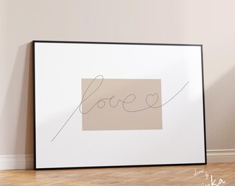 May include: A framed print with a minimalist design featuring the word "love" written in a single continuous line with a heart shape at the end. The word is centered on a light brown rectangle against a white background.