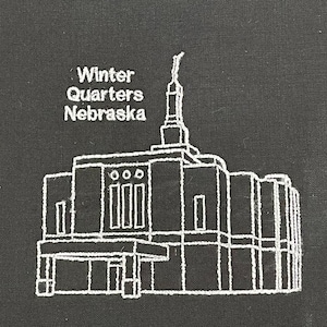 May include: White embroidered outline of the Winter Quarters Nebraska Temple on a black fabric background.