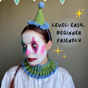 May include: A crocheted clown hat and collar set in green and blue, with a blue pom-pom on top of the hat. The image includes the text "LEVEL: EASY, BEGINNER FRIENDLY". The clown has white face paint with pink, teal, and black accents.