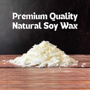 May include: A pile of white soy wax flakes, labeled "Premium Quality Natural Soy Wax" on a dark background.