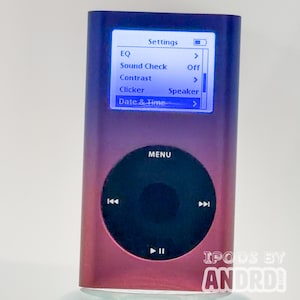 May include: A gradient purple and red iPod with a screen displaying settings options. The device has a circular control pad with a menu button and navigation controls. The text "IPODS BY ANDRD" is visible at the bottom.