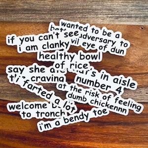May include: A collection of white stickers with black text. The stickers have phrases like "if you can't see adversary to", "healthy bowl of rice", "say she of ur's in aisle", "ti' cravina number 4", "farted at the risk of feeling dumb chickennn", "welcome to tronch bendy toe", and "i'm a".