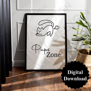 Op de afbeelding: Zwart-witte printbare wandkunst met een cartoonkat met de tekst "Pups Zone".