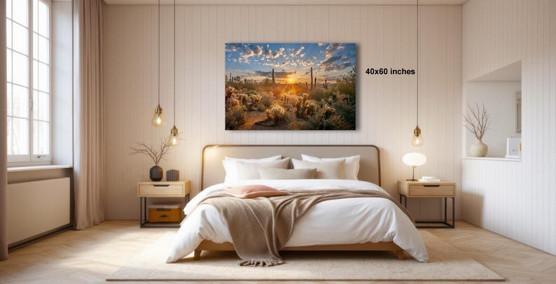 a serene bedroom with a large bed, wooden furniture, and a painting of a desert landscape hanging on the wall.