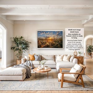 The image is a large framed picture hanging on a wall in a spacious living room. The room has a modern and elegant design, with a large sectional sofa, a coffee table, and various decorative elements such as potted plants and vases.