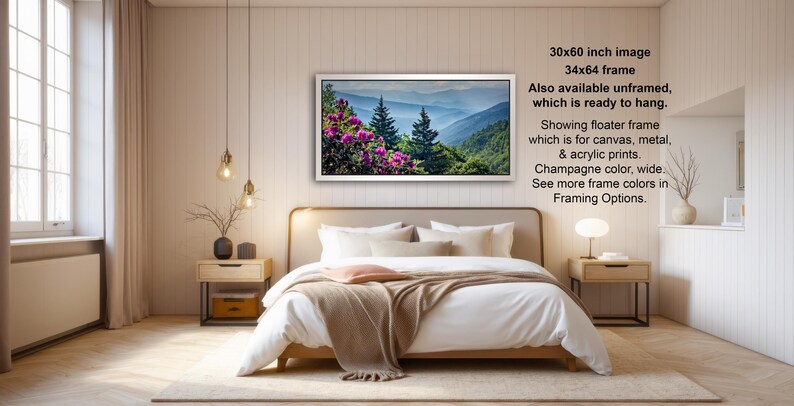 The image is a modern bedroom with a large bed, wooden furniture, and a framed landscape photograph hanging on the wall.