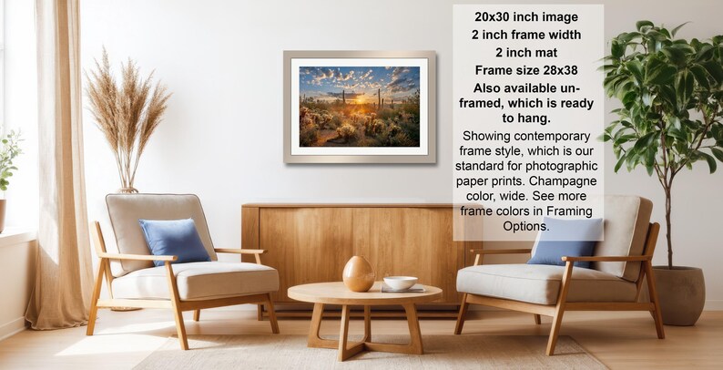 The image is a living room with a framed landscape painting hanging on the wall, a wooden coffee table in the center, and two chairs facing each other.