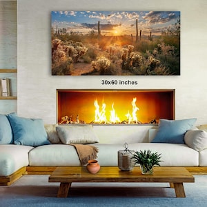 a cozy living room with a fireplace, a large framed landscape painting on the wall, and a wooden coffee table in front of the fireplace.