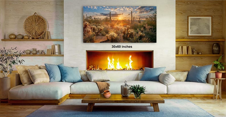 a cozy living room with a fireplace, a large framed landscape painting on the wall, and a wooden coffee table in front of the fireplace.