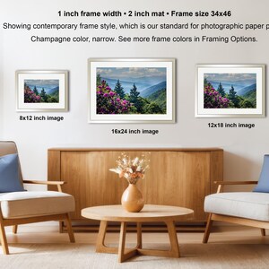 a living room with three framed landscape photographs hanging on the wall. The photographs are of varying sizes, with the largest one being 16.24 inches in size and the other two being 12.12 and 8.12 inches in size. The room is furnished with two chairs and a coffee table, and there are potted plants and a vase adding to the decor.