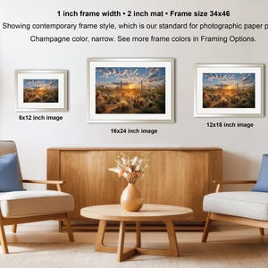 a living room with three framed landscape photographs hanging on the wall, arranged in a row. The photographs are of varying sizes, with the largest one being 8x12 inches and the smallest one being 16x24 inches. The room is furnished with two armchairs and a coffee table, and there are potted plants and a vase adding to the decor.