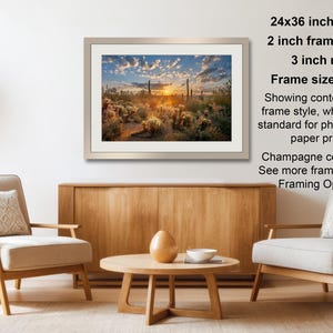 a living room with a wooden coffee table, two white armchairs, and a framed landscape photograph hanging on the wall.
