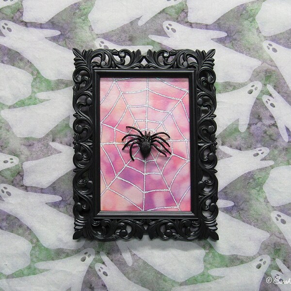 framed spider on spiderweb assemblage - hot pink bokeh - by Sarah Knight, glitter black plastic halloween decor wall art scary but cute