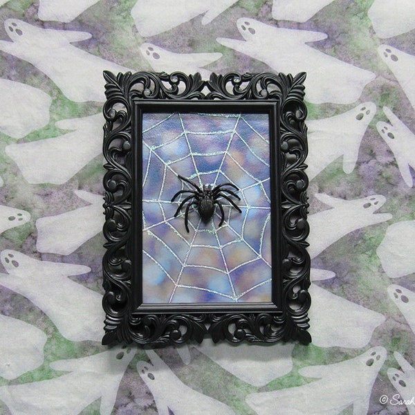 framed spider on spiderweb assemblage - blue bokeh - by Sarah Knight, glitter black plastic halloween decor wall art scary but cute