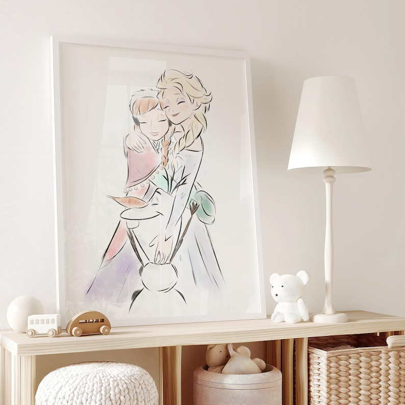 May include: A framed art print featuring a watercolor illustration of two animated female characters embracing. The artwork is in soft pastel colors, with a focus on the characters' faces and flowing dresses. The print is displayed on a light-colored wooden shelf.