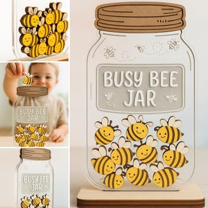 May include: A clear acrylic jar with a wooden lid and base, filled with yellow and black bee cutouts. The jar has the words "Busy Bee Jar" on the front. The bees have smiling faces.