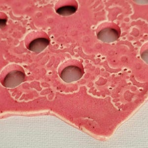 Handmade Flower Frog with exquisite detail, glazed in a beautiful coral.