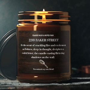 May include: A brown glass candle jar with a label that reads "221B Baker Street". The label has a quote about the scent of crackling fire and excitement as Holmes deciphers a coded letter. The candle is on a dark surface.