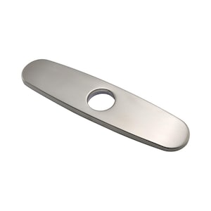May include: A brushed nickel faucet deck plate featuring an elongated oval shape with rounded ends and a single centered circular hole. This metal escutcheon plate has a smooth, matte finish and is designed to cover unused mounting holes.