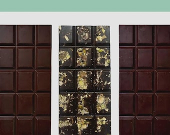 May include: Three dark chocolate bars. The center bar is studded with pistachios. The top of the image reads "70's Collection" and "70% Classic/Pistachio-Coconut/Sea Salt." The bottom of the image reads "SPICE ISLE CRAFT Chocolate."