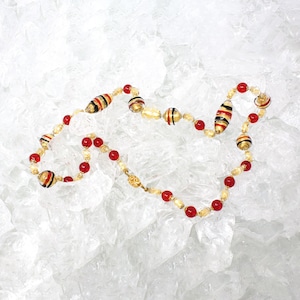 Unique piece! Vintage Murano glass necklace with handmade golden and red pearls, with black decorations and gold leaf, Made in Italy