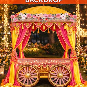 May include: A colourful Mehndi photo booth backdrop. The structure is yellow and pink, decorated with floral arrangements and tassels. The booth has large spoked wheels and is set on grass, with fairy lights in the background.