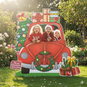 May include: A red Christmas-themed photo booth prop shaped like a car, with three children inside. The car is decorated with a Christmas tree, gifts, and a wreath. The sign reads "Merry Christmas PHOTO BOOTH."