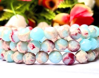 May include: A multi-strand bracelet made of light blue and white marbled beads with red accents.