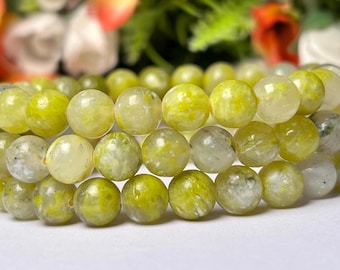 May include: A bracelet made of green and white jade beads. The beads are round and have a smooth, polished finish.