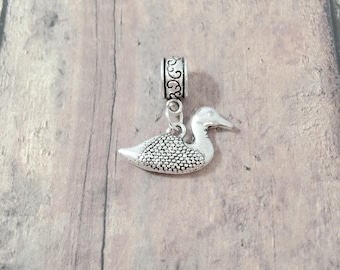 May include: Silver charm featuring a detailed duck design with a decorative bead at the top. The charm is suitable for use with a charm bracelet or necklace.
