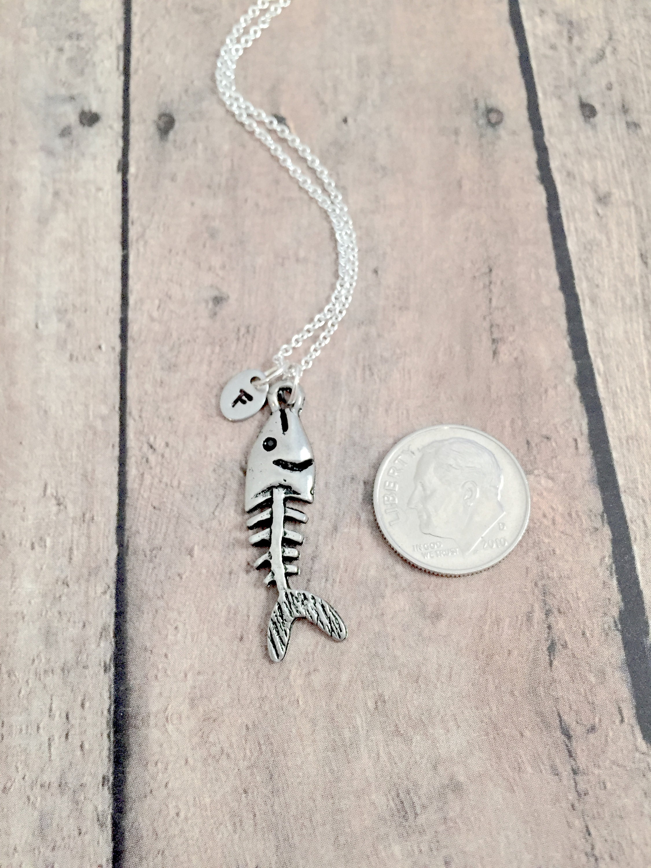 Necklace - string and metal pendant, patinous fish skeleton