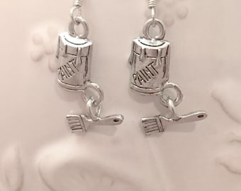 May include: Silver paint can and paintbrush dangle earrings. The paint can has the word "PAINT" on it.