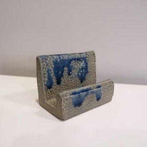 May include: A rustic wooden sign with the text "Welcome to our home" in white lettering. The sign features a distressed finish and a simple, inviting design, perfect for entryway decor.