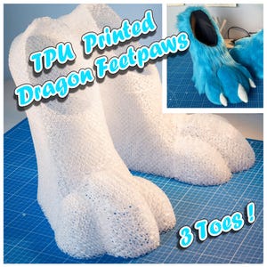 May include: White TPU printed dragon footpaws with three toes. The footpaws are on a blue cutting mat. The text "TPU Printed Dragon Feetpaws" and "3 Toes!" are written in blue on the image.
