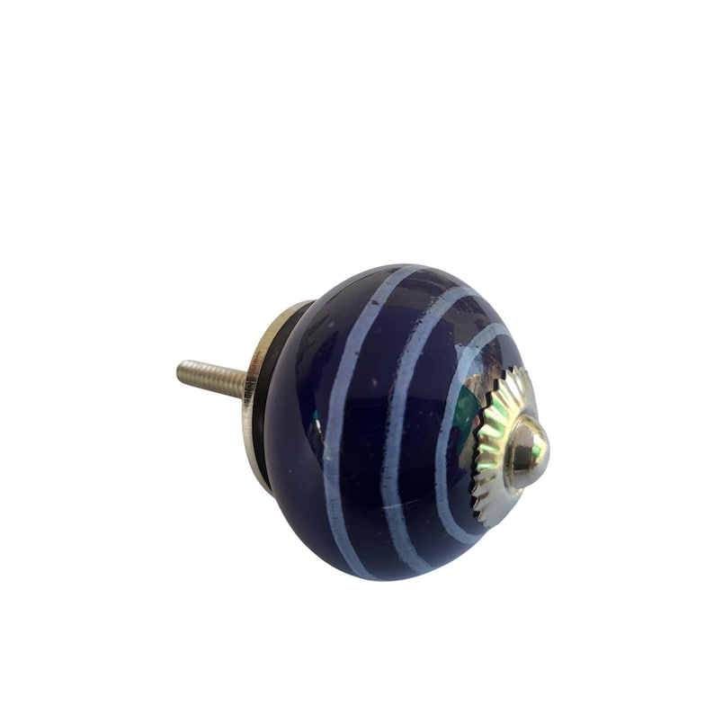 May include: A navy blue ceramic cabinet knob with light blue stripes. The knob has a silver-coloured metal base and screw. This decorative hardware is suitable for drawers, cabinets, and furniture.
