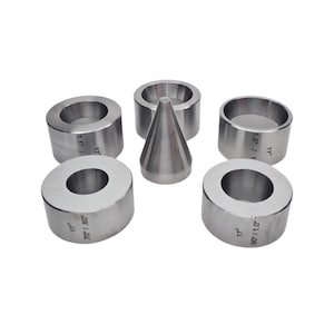 May include: A set of five silver metal tools, including four ring-shaped pieces and one conical piece. The ring-shaped pieces have measurements such as 1.1" / 1, 1.5" / 1, 70"/.80", and 90"/1.0" with 17° markings.