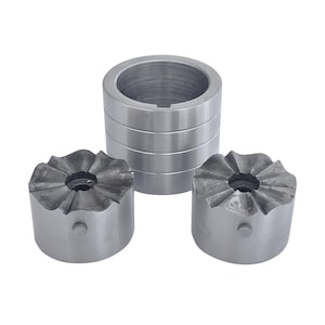 May include: Three silver metal tools. Two have a fluted, flower-like edge and a central hole. The third is a cylindrical shape with a hollow centre and horizontal grooves. All are set against a white background. Metric measurements apply.