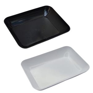 May include: Two rectangular trays, one black and one white, are displayed against a white background. The trays have slightly raised edges and a glossy finish. The black tray is positioned above the white tray.
