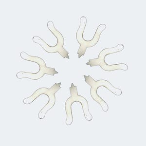 May include: Eight silver metal U-shaped pieces arranged in a circle. The pieces are all the same size and shape, and they are evenly spaced around the circle.