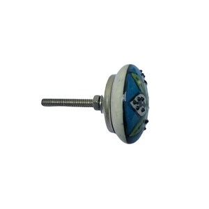May include: A decorative cabinet knob with a round, ceramic face. The knob features a blue and green floral design with a white border. The metal hardware includes a threaded bolt and a nut for secure installation.